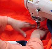 Closeup of the expert sewing in our custom applique banners