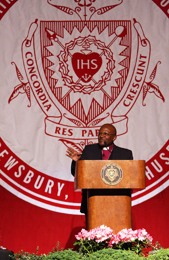 Bishop Desmond Tutu, speaking at St. John's commencement ceremeony, with custom applique banner in background