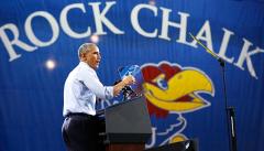 President Obama speaking in front of giant applique Rock Chalk banner
