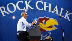 President Obama speaking in front of giant applique Rock Chalk banner